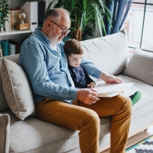 grandad reading to son